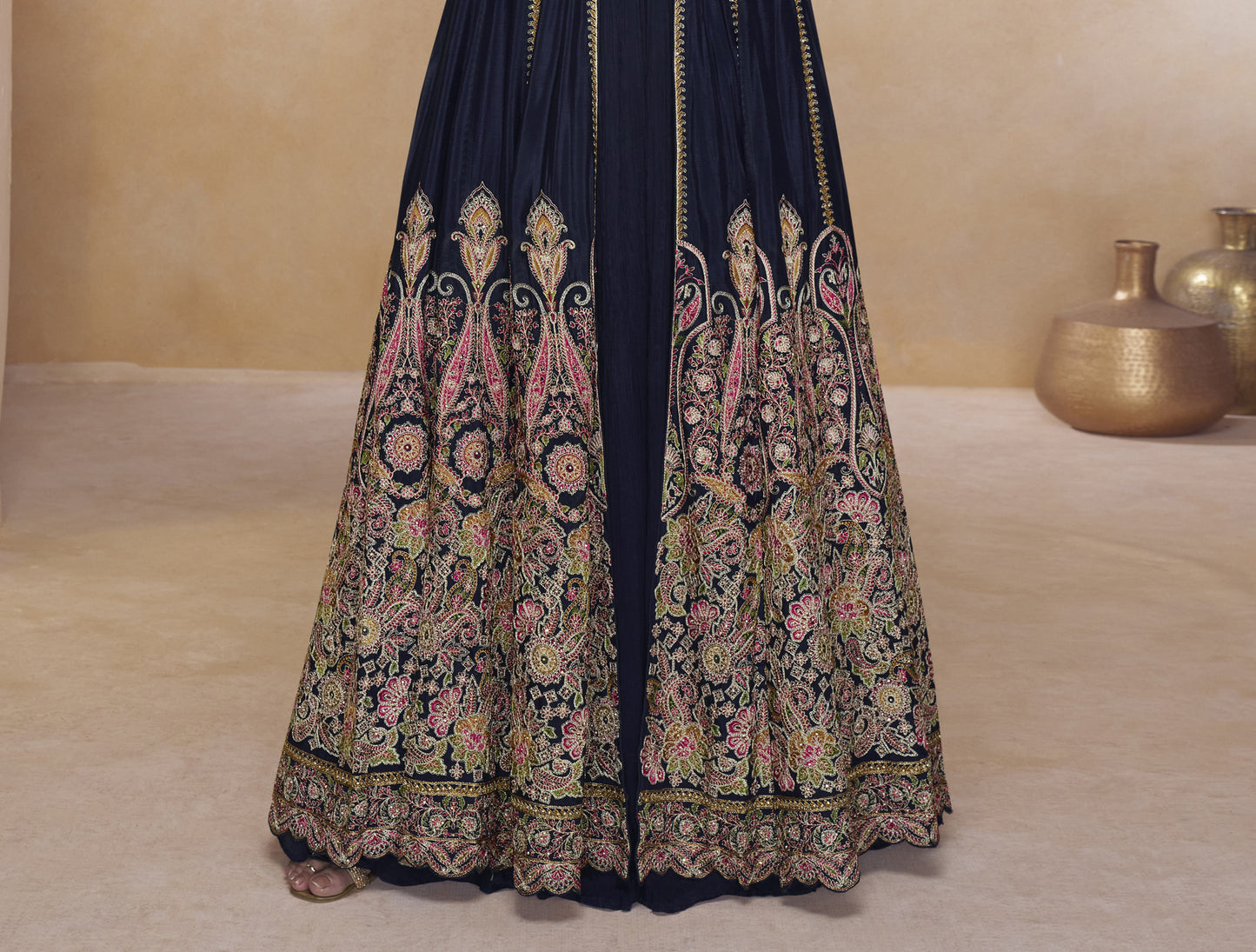 Close-up of black designer Anarkali gown with ornate embroidery, matching crop top, and full-length embellished jacket