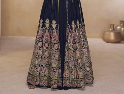 Close-up of black designer Anarkali gown with ornate embroidery, matching crop top, and full-length embellished jacket