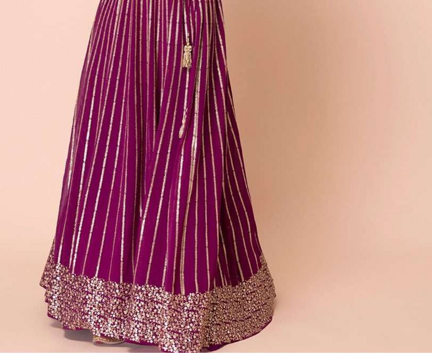 Detail shot of zari embroidery pattern on lehenga choli panel
