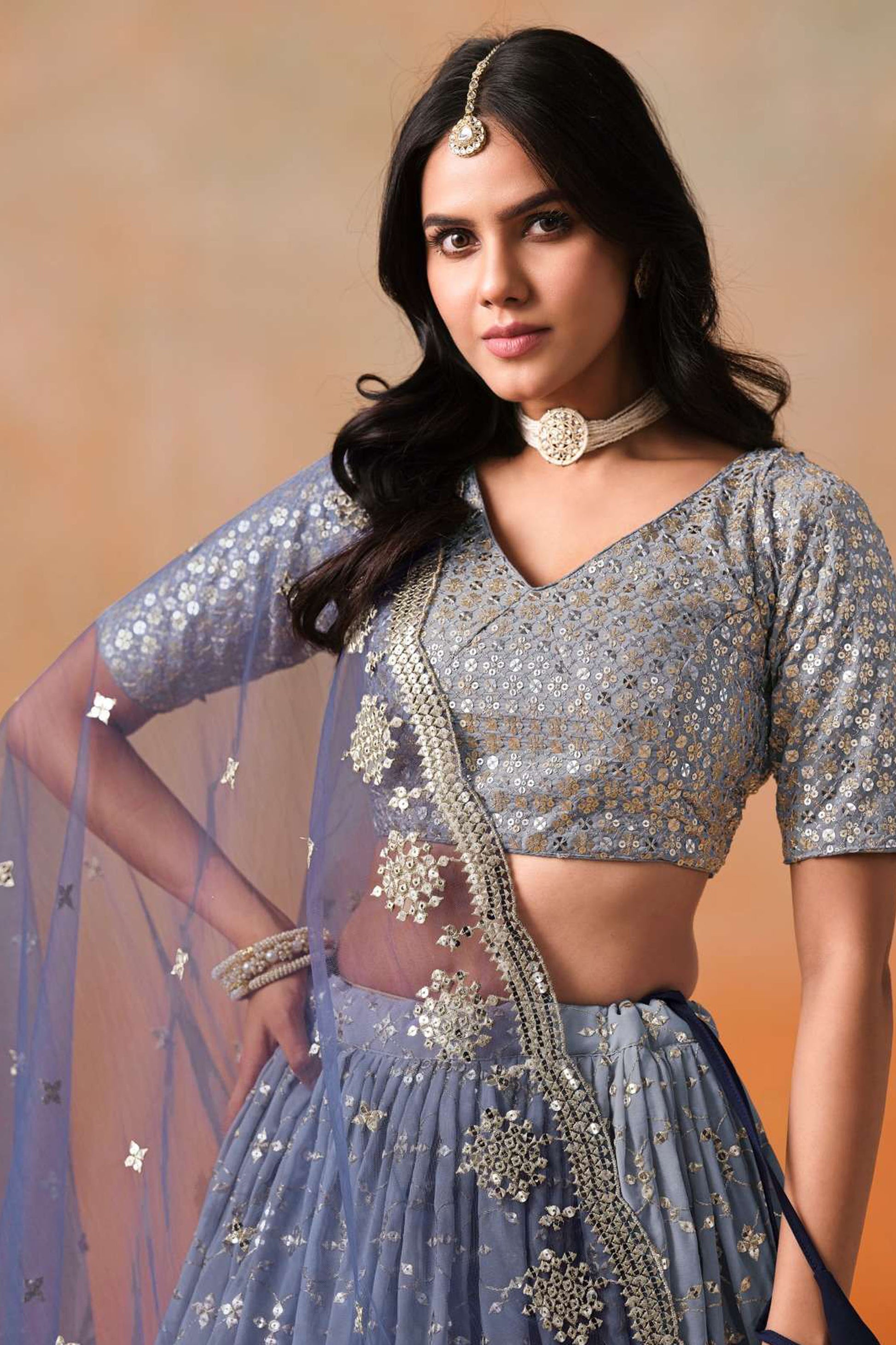 Close-up of sequins zari embroidery on blue lehenga