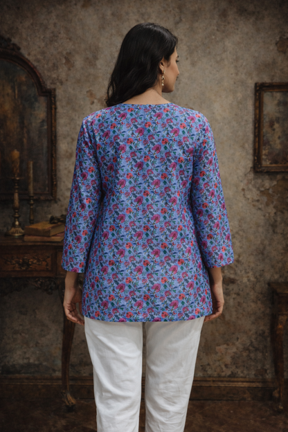 Back profile of blue top with soft drape finish