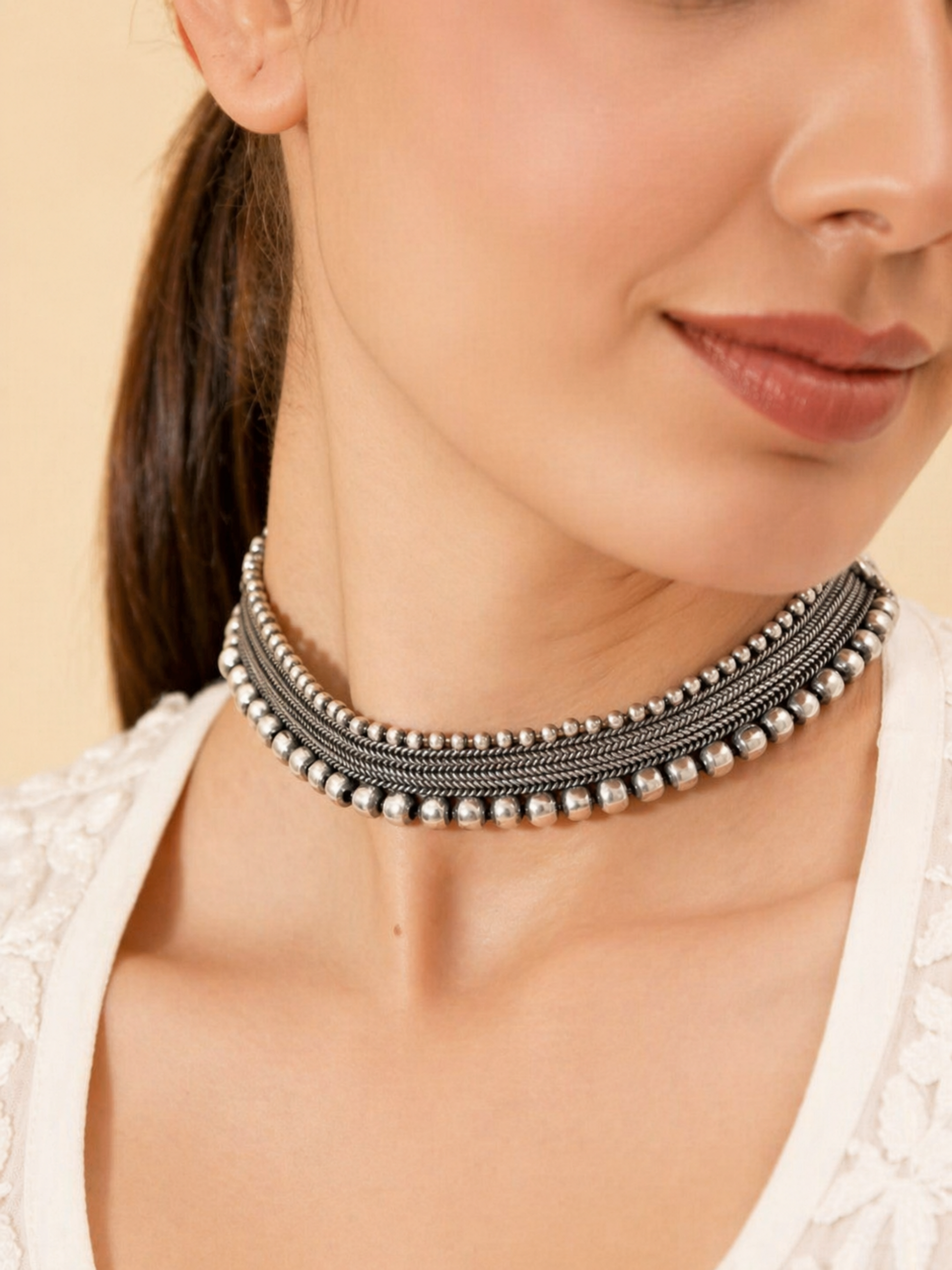 model wearing silver tribal choker necklace