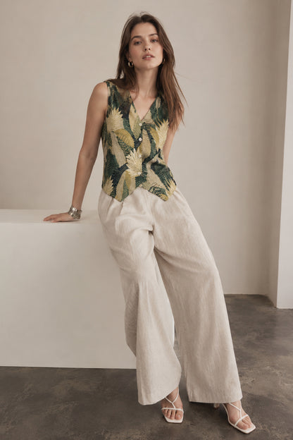 Front view of sleeveless vest top women with button closure detail