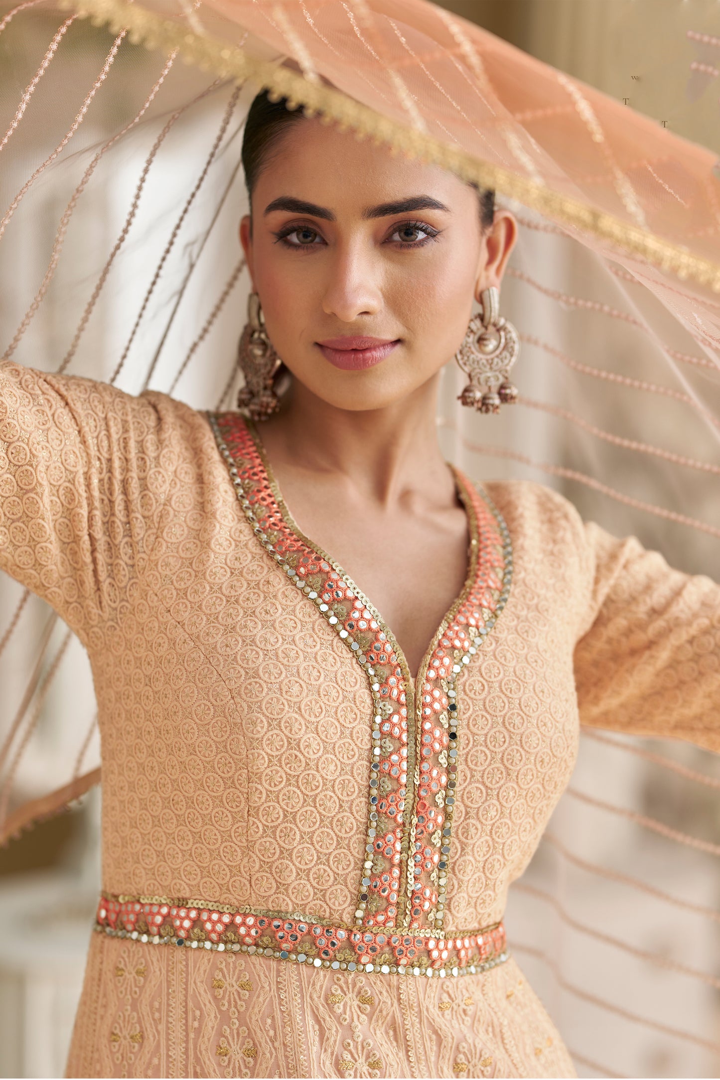 Close up of chikankari embroidery on peach anarkali