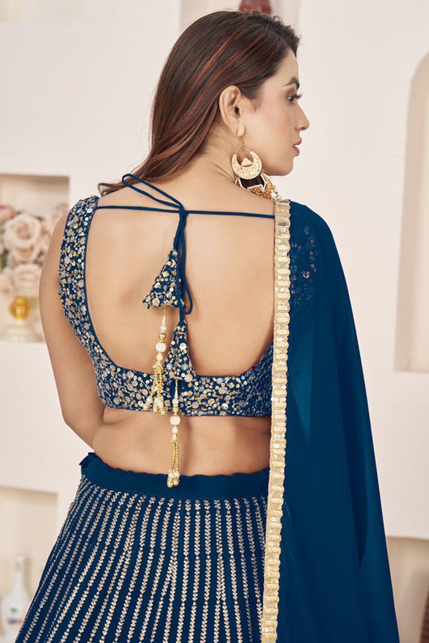 Close-up of sequins and zari embroidery on georgette fabric