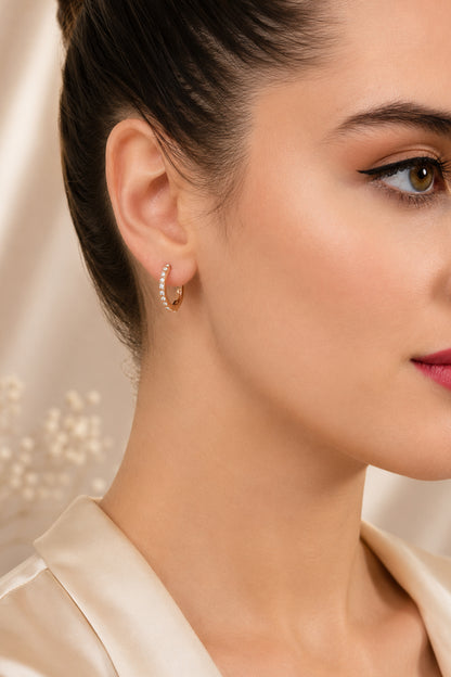 Gold-tone hoop earring with a polished drop detail