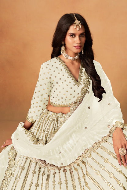 close view of heavy embroidery work on off-white lehenga choli