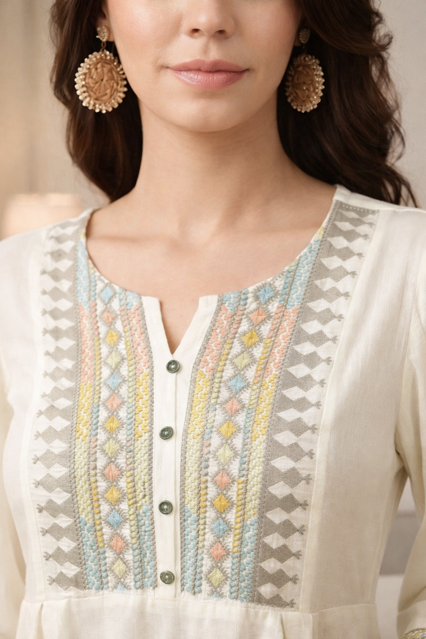 Close-up of floral embroidered detail on cotton tunic
