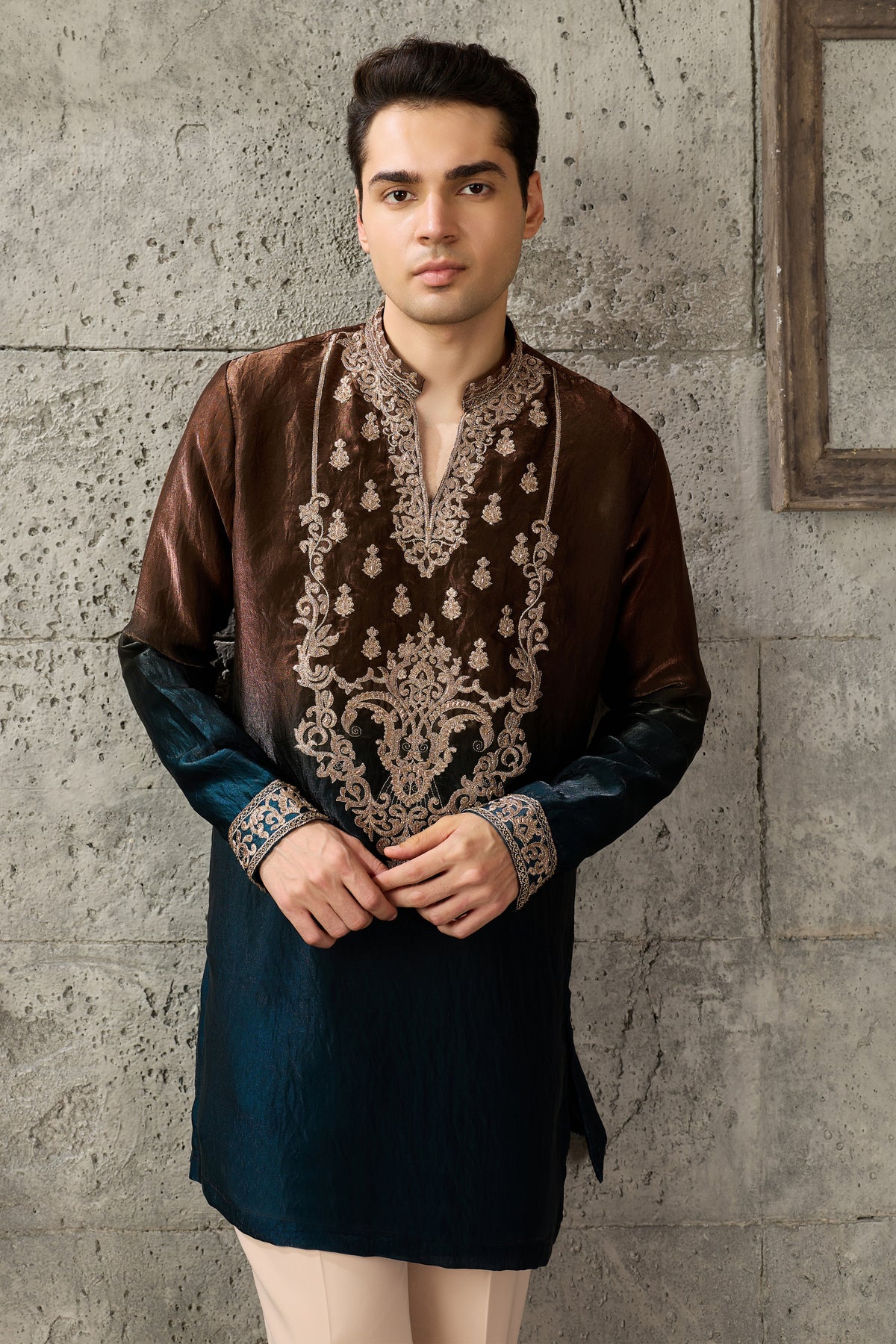 Close-up of thread embroidery on the brown kurta