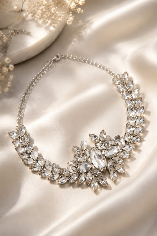 Crystal leaf necklace with layered clear stones on satin fabric