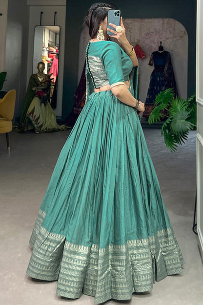 Side profile of cyan lehenga with intricate woven patterns
