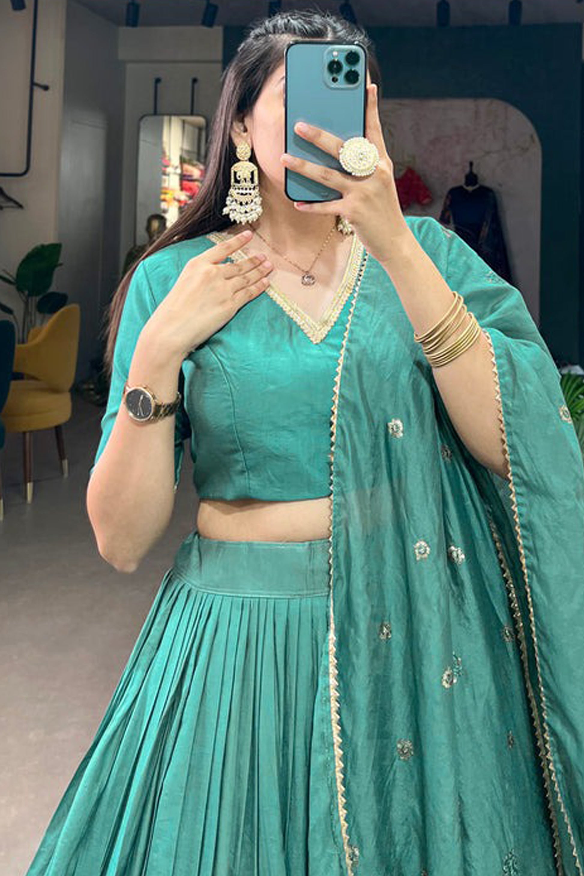 Close-up of woven motifs on cyan lehenga choli