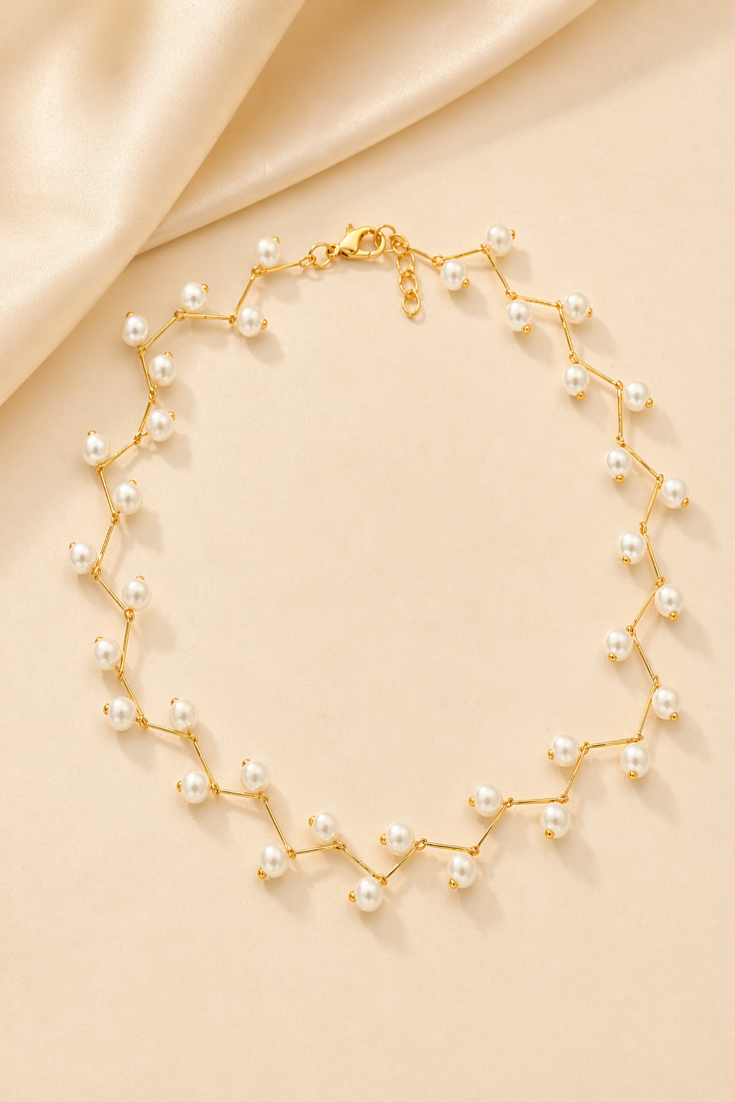 dainty gold pearl necklace flat lay
