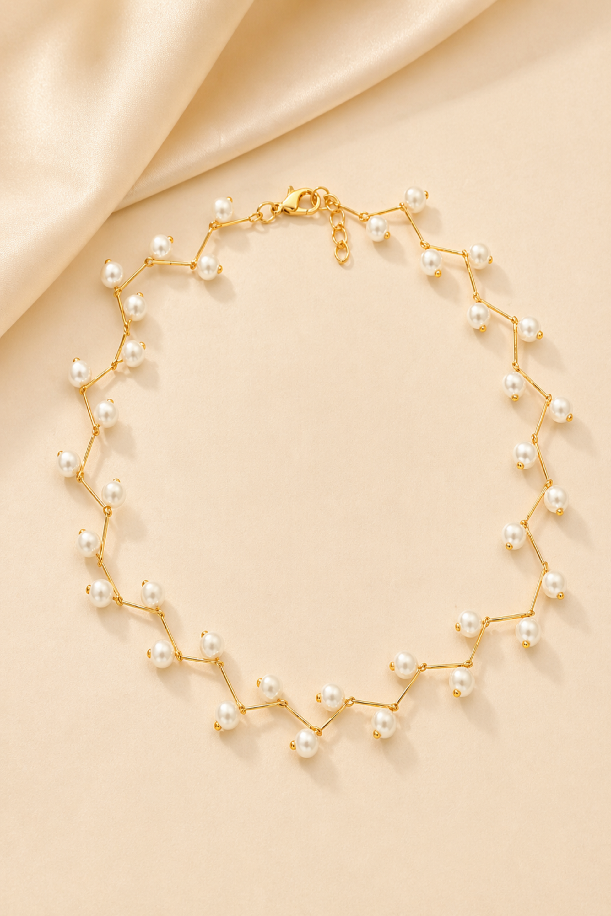 dainty gold pearl necklace flat lay
