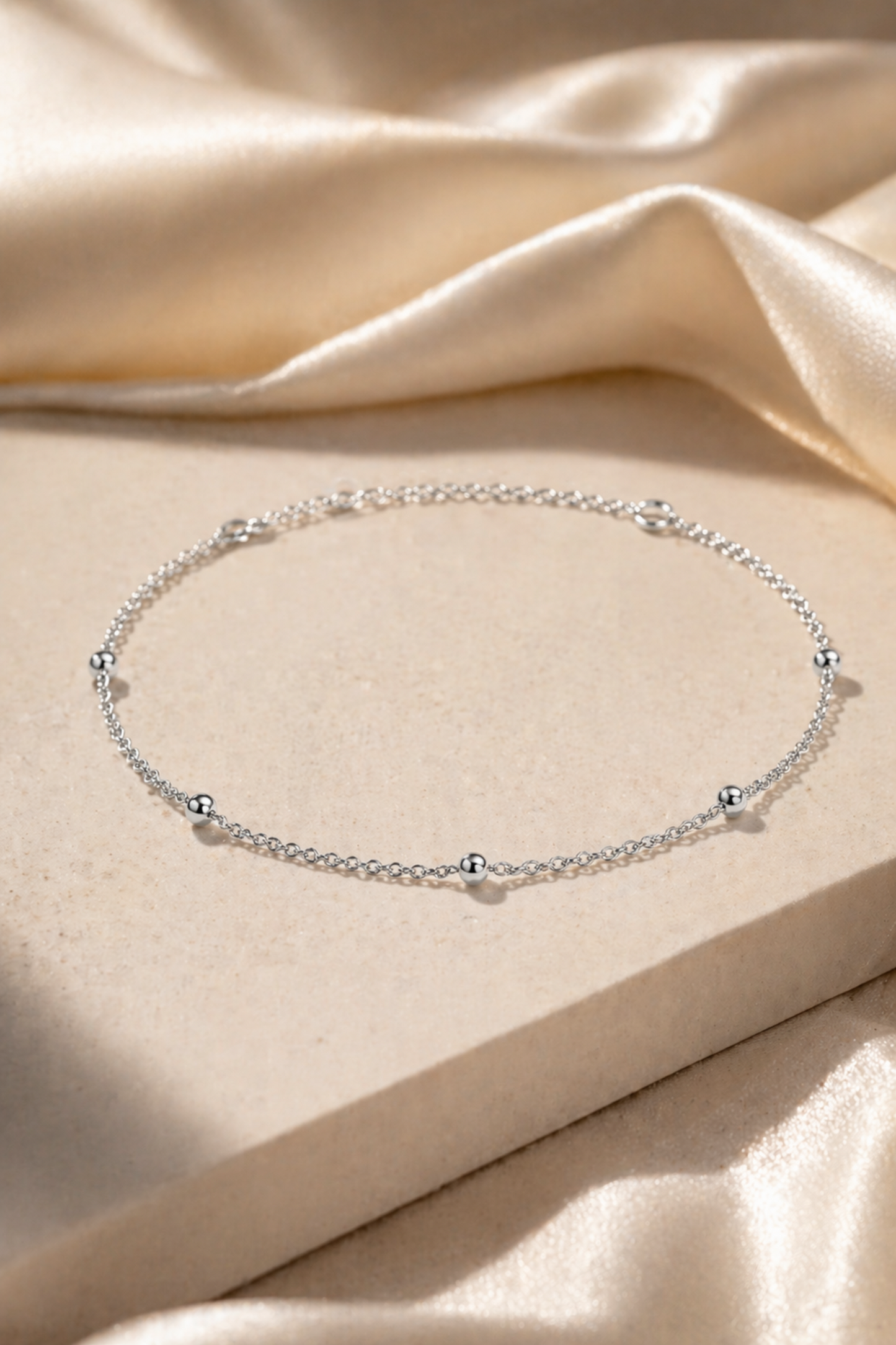silver bead anklet on ankle close up
