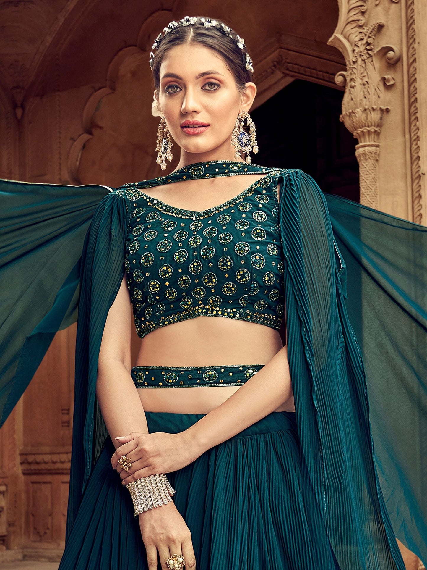 Close-up of thread embroidery on dark blue choli