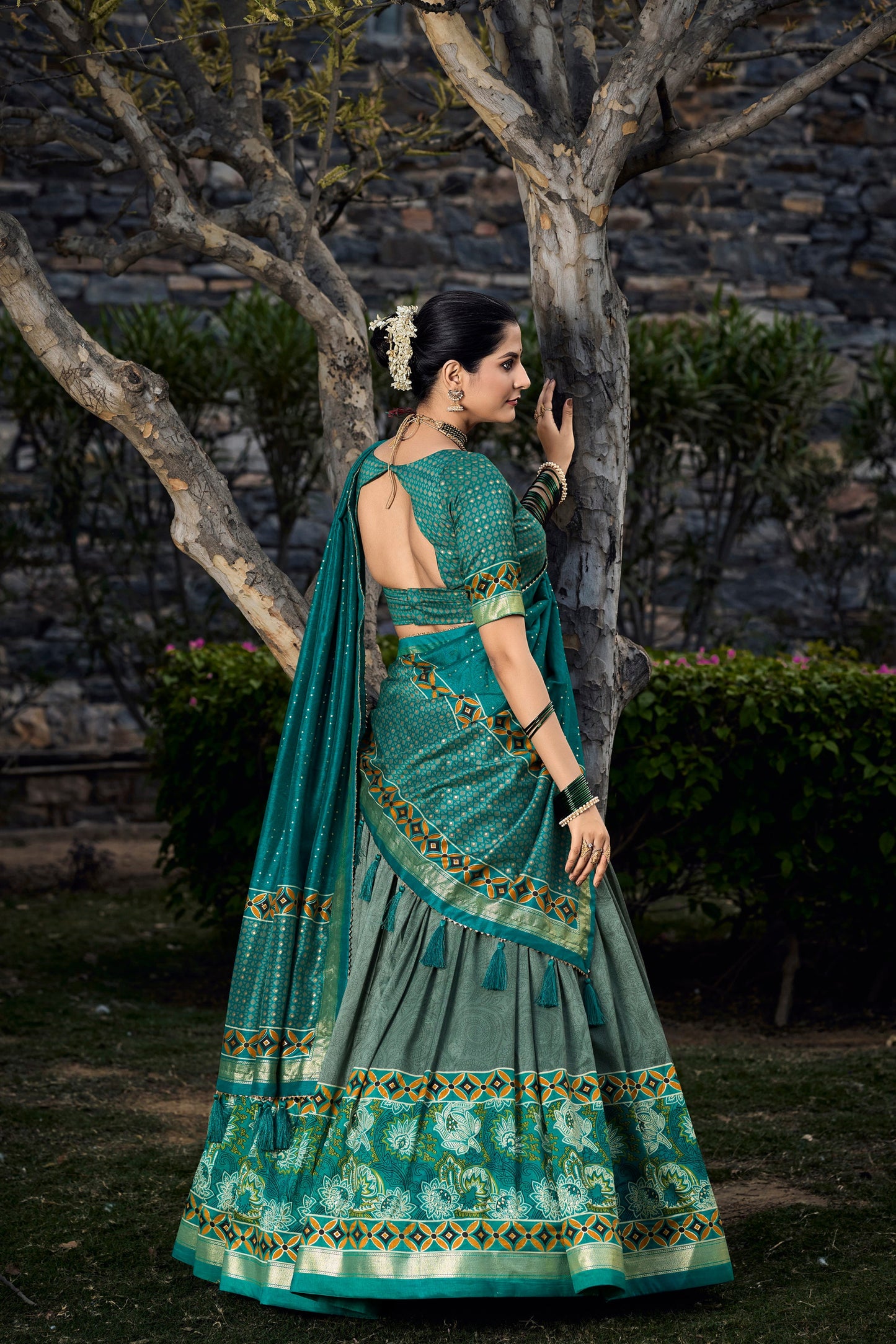 Back view of dark green lehenga choli with printed design