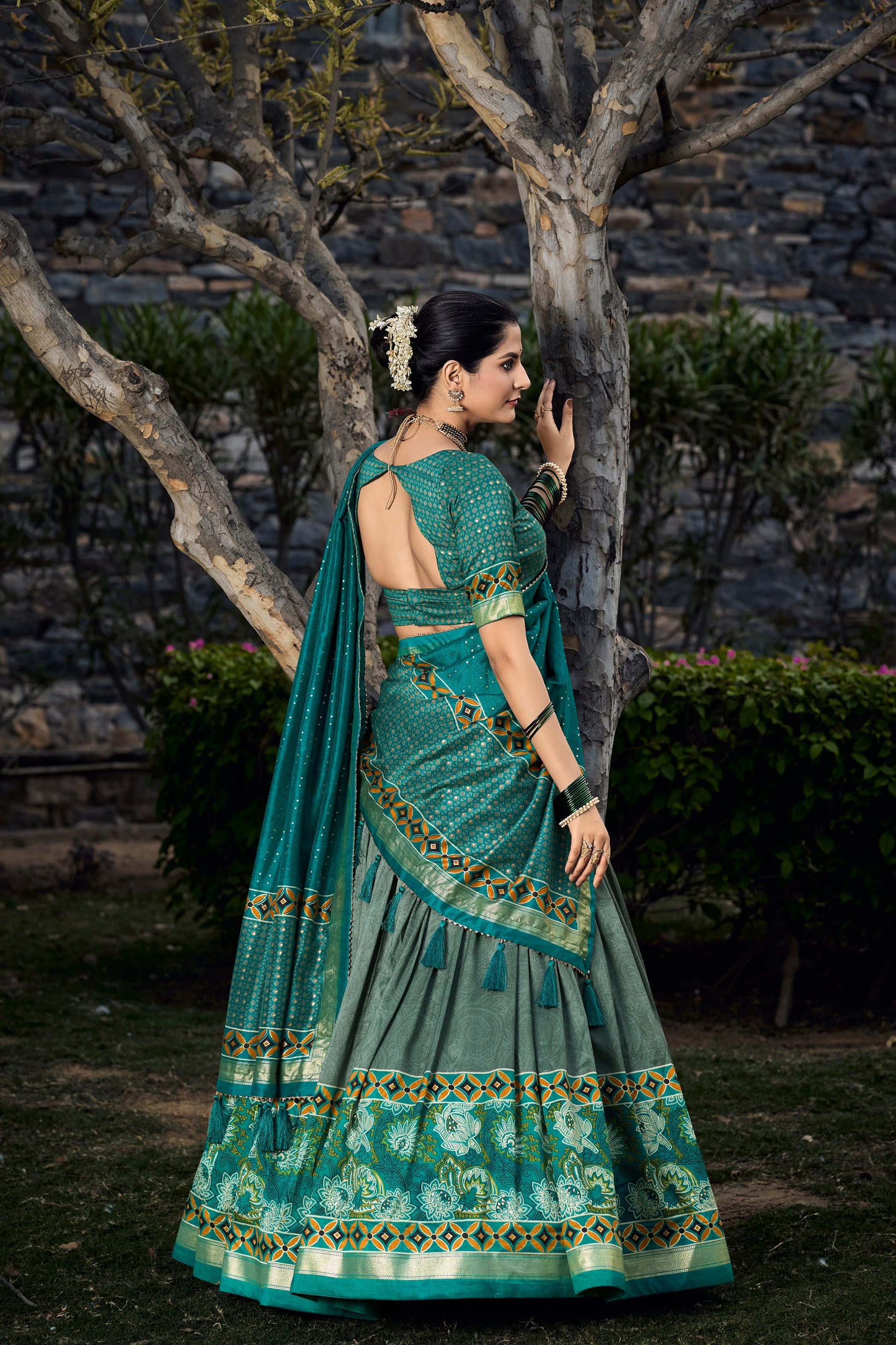Back view of dark green lehenga choli with printed design