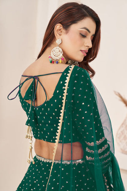 Close-up of zari work on dark green lehenga skirt