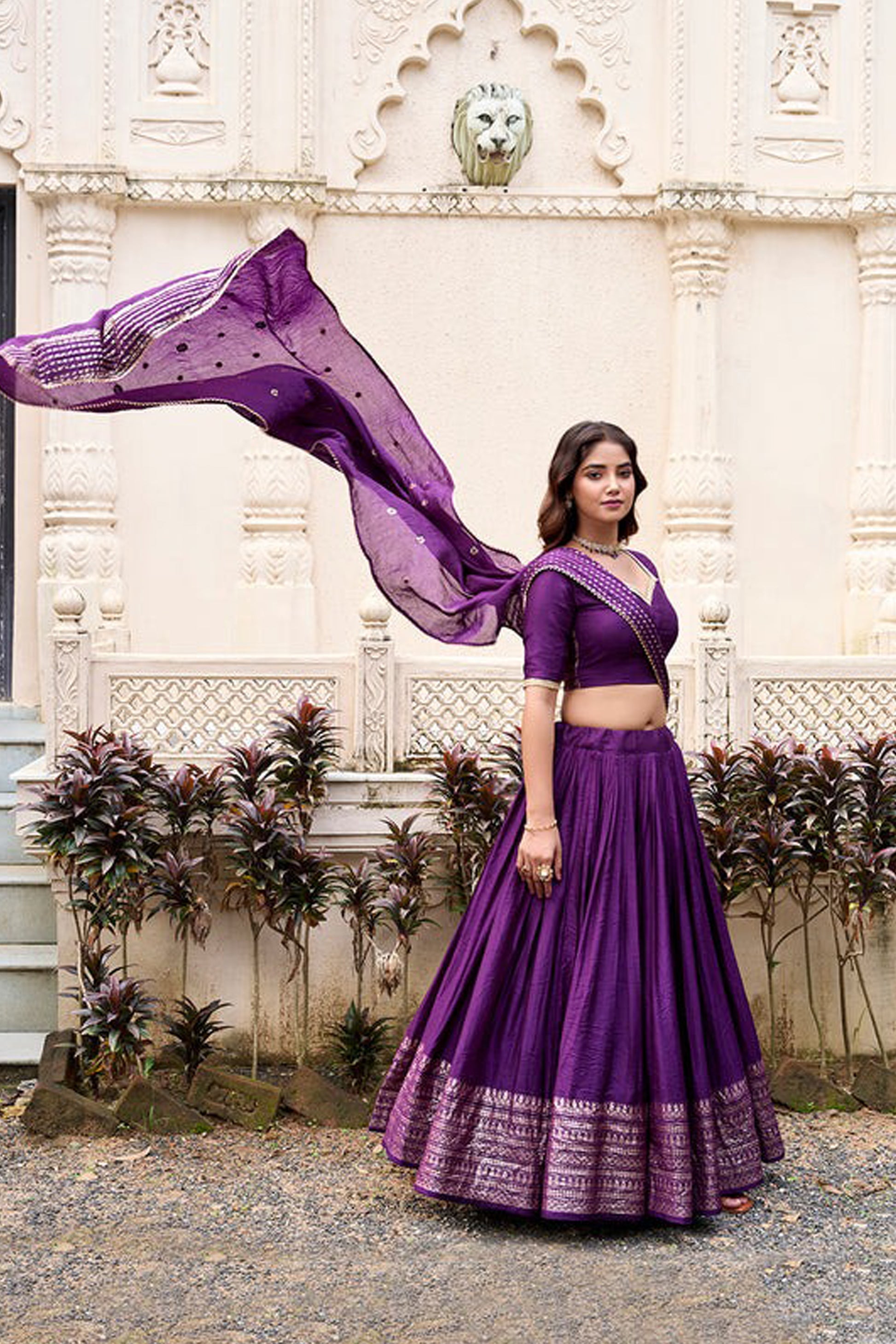 Traditional zari weaving pattern on purple lehenga fabric