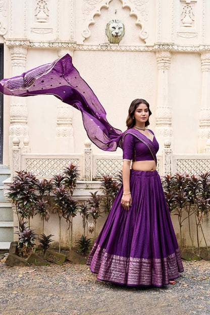 Traditional zari weaving pattern on purple lehenga fabric