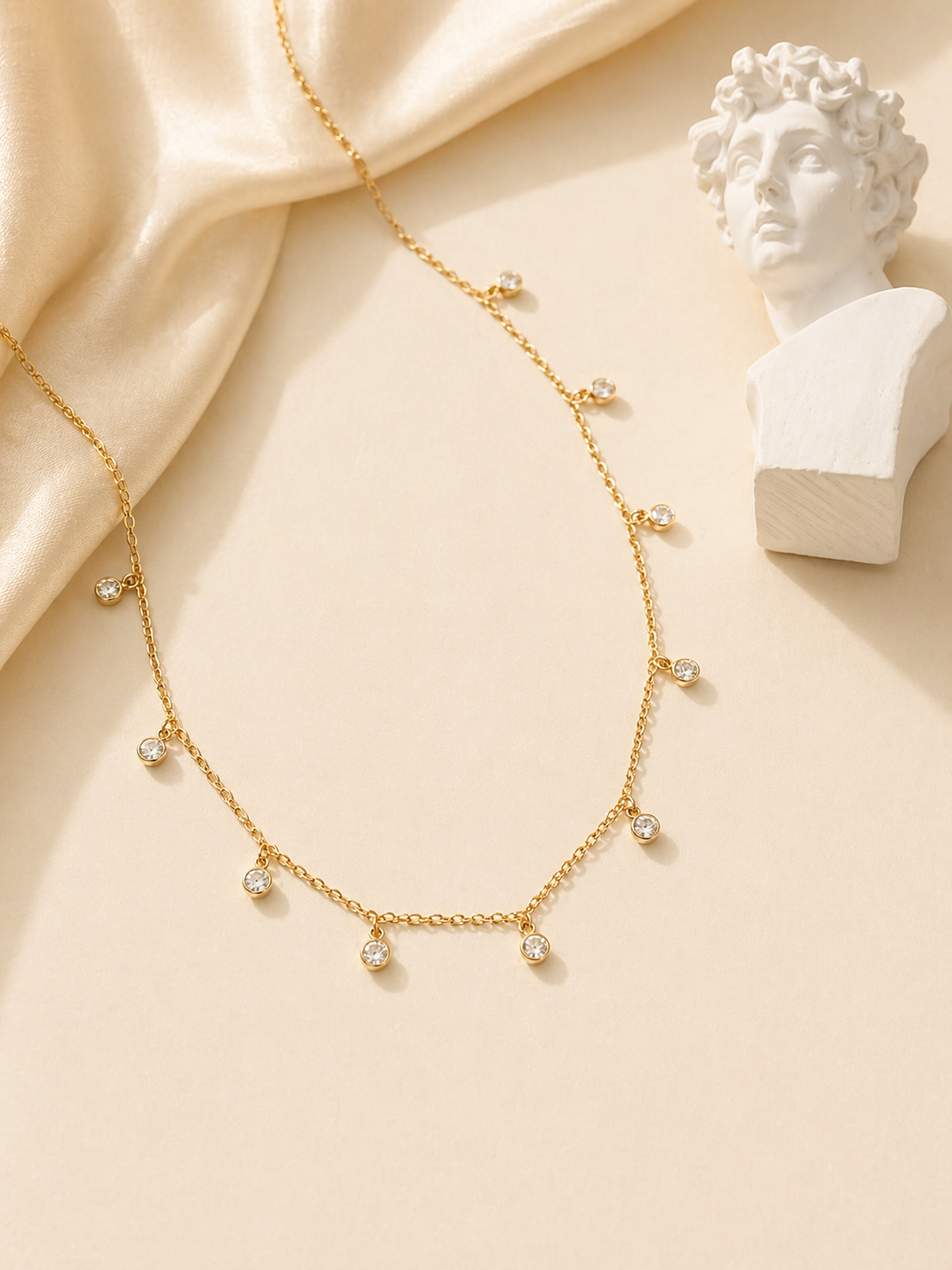 simple gold necklace with tiny stones
