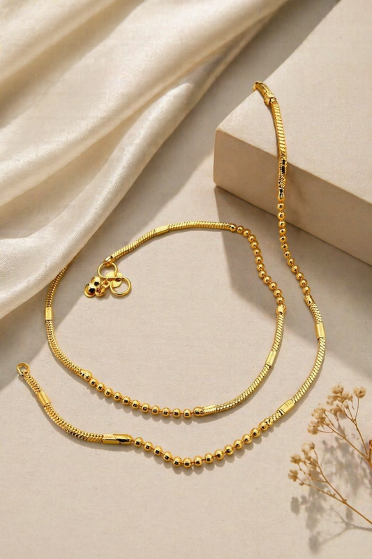 gold anklet with bead and chain design in box