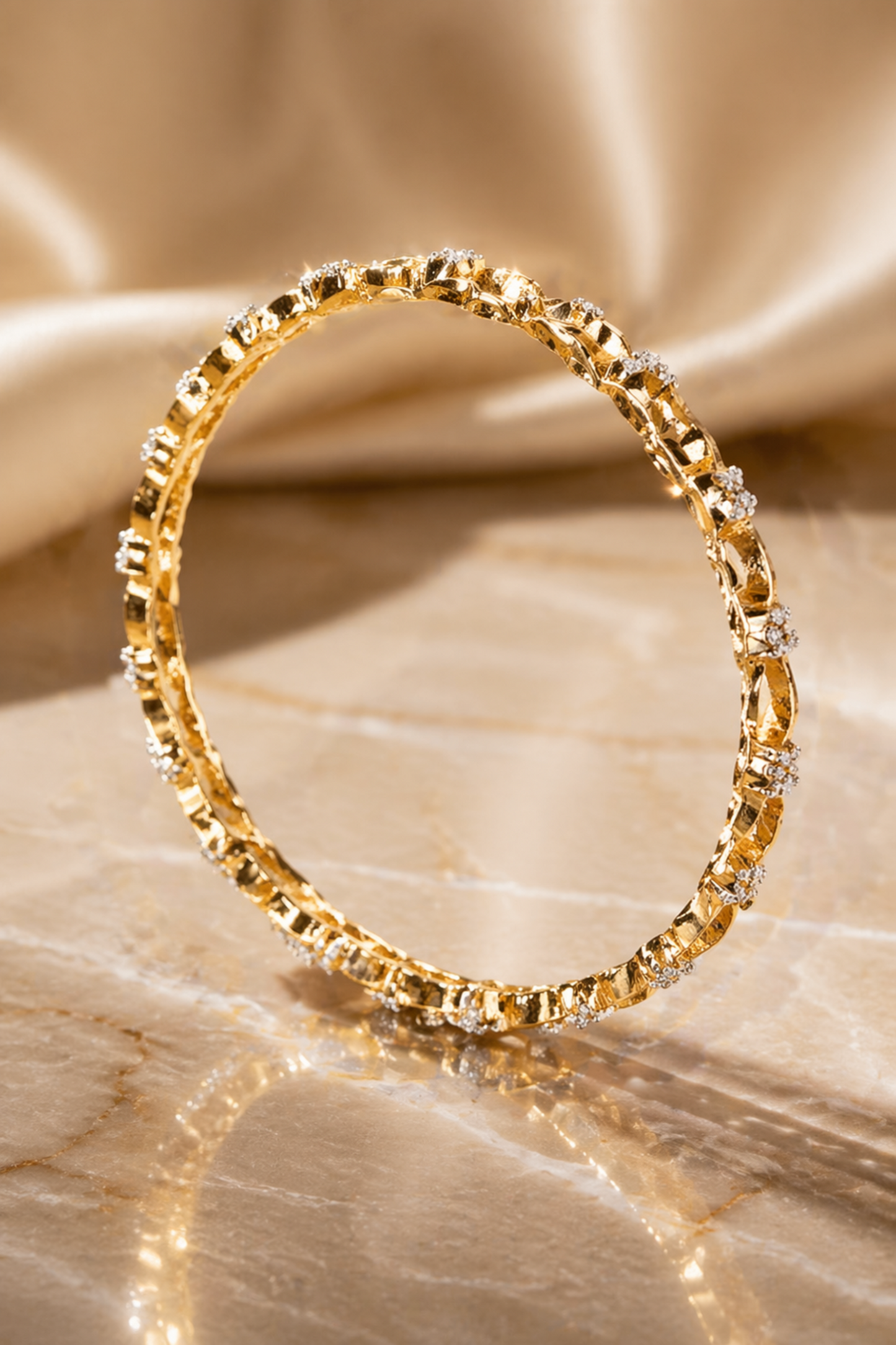 twisted chain style bangles on marble surface