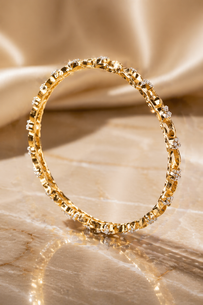 twisted chain style bangles on marble surface