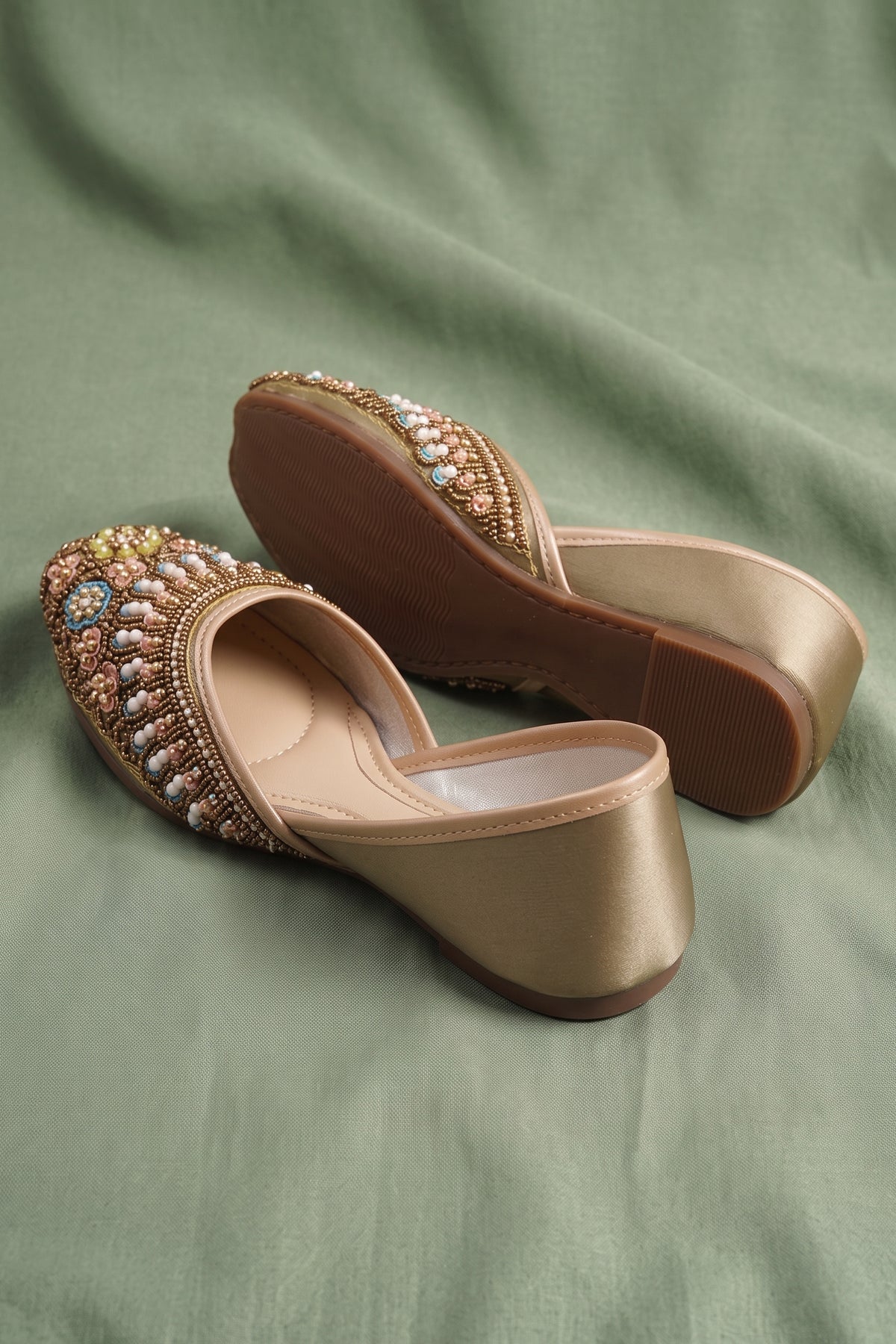 Detailed view of heavy bead and sequin embroidery on ethnic shoes