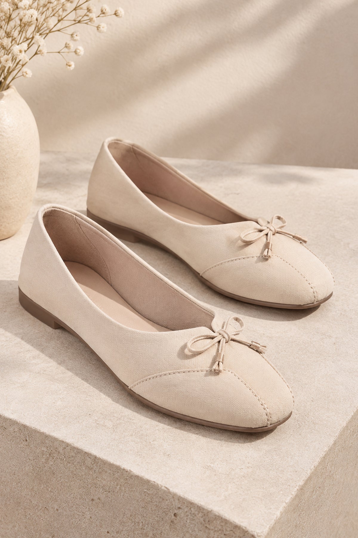 Minimal ivory ethnic flats with stitched toe detailing