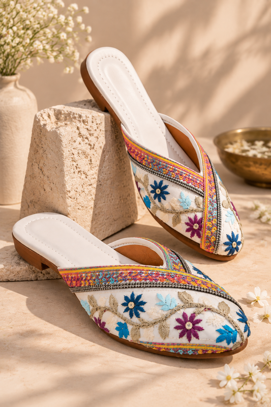 Ivory embroidered mojri with colorful floral detailing and traditional Indian design