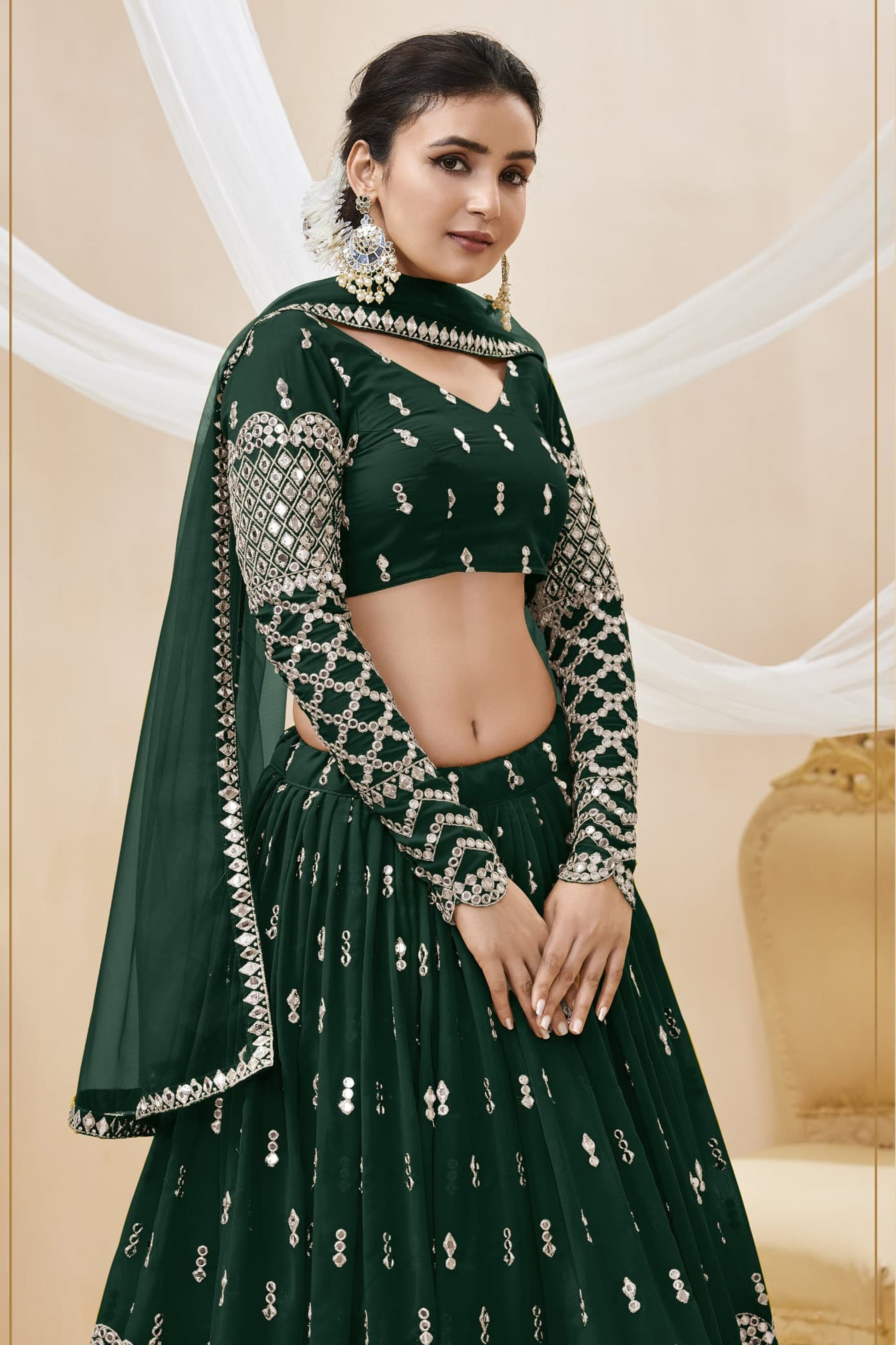 Close-up of sequins embroidery on dark green lehenga