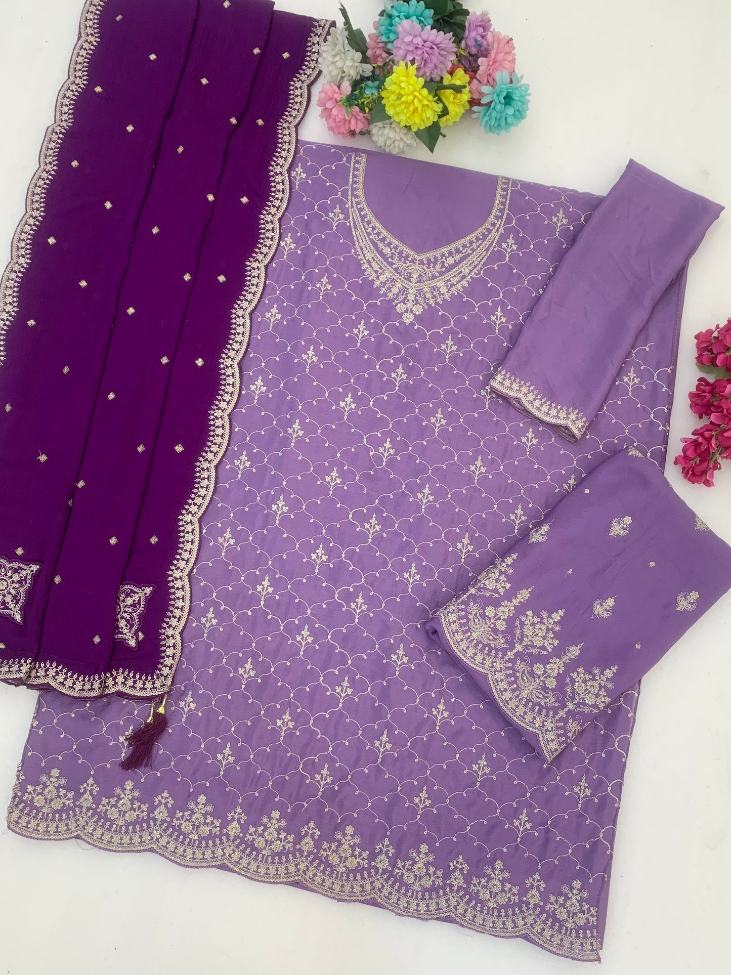 Neckline embroidery detail on royal purple outfit