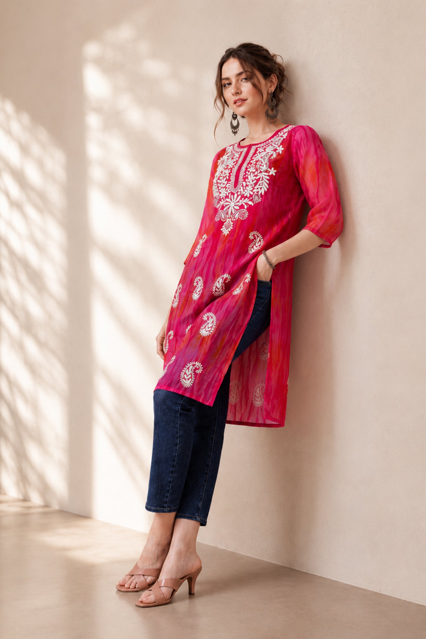 Model styling a simple kurti with statement earrings and clutch