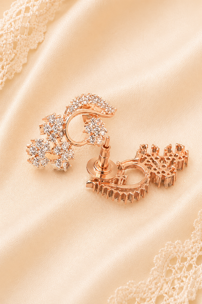 Light-catching earrings on satin background