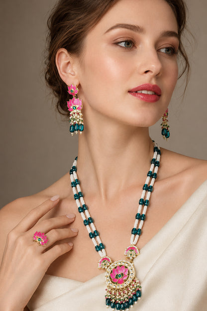 Pink green statement jewelry shown on cream marble and softly draped fabric