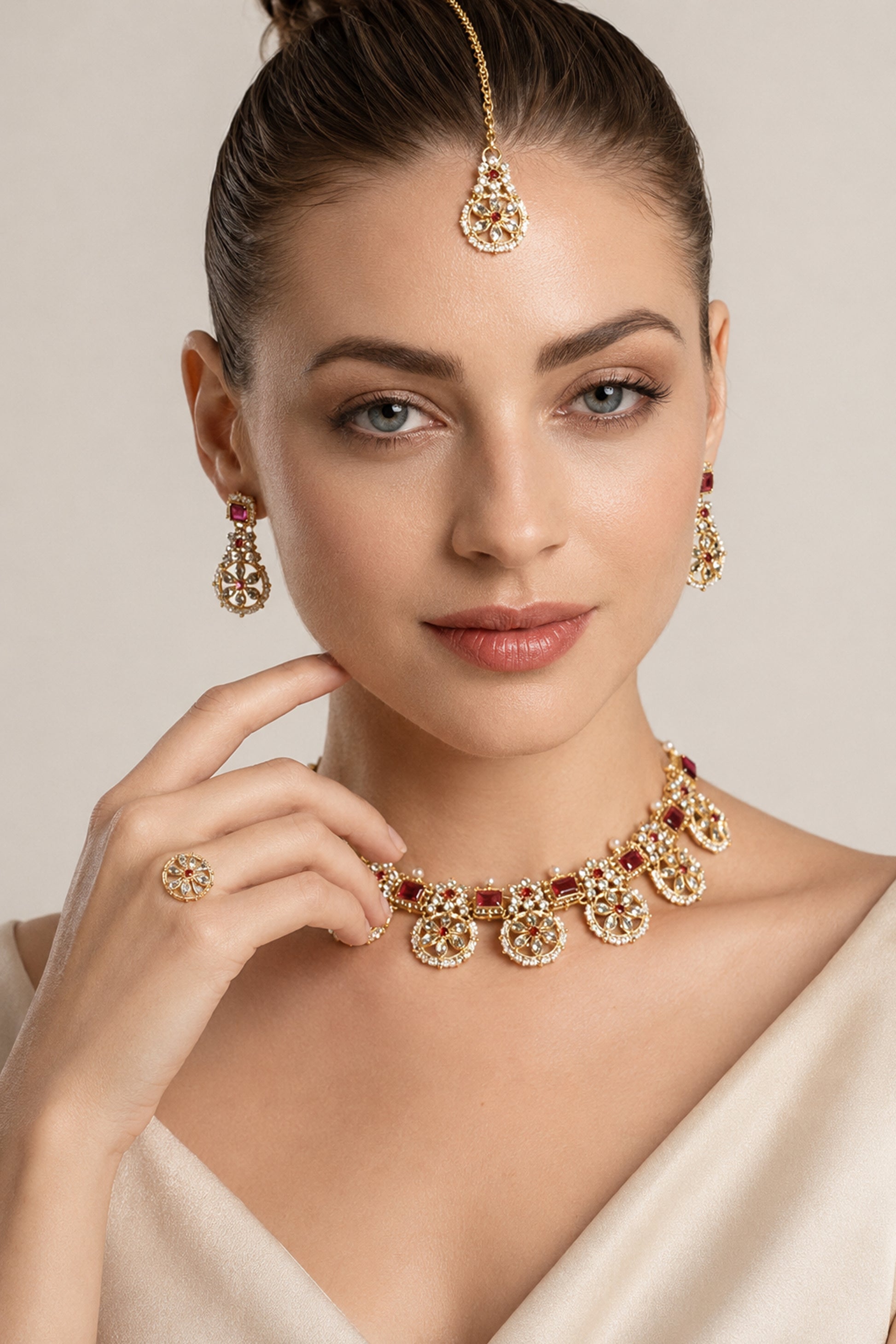 Full necklace set arranged with earrings, ring and matching forehead ornament