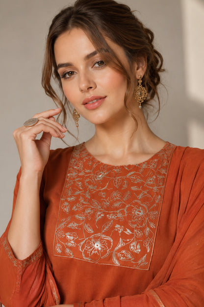 Close-up of floral printed thread work on the orange silk top