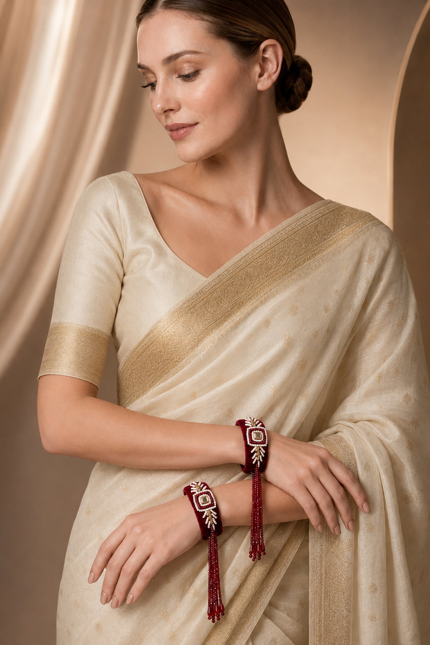 European model wearing maroon fringe bangles with a cream saree