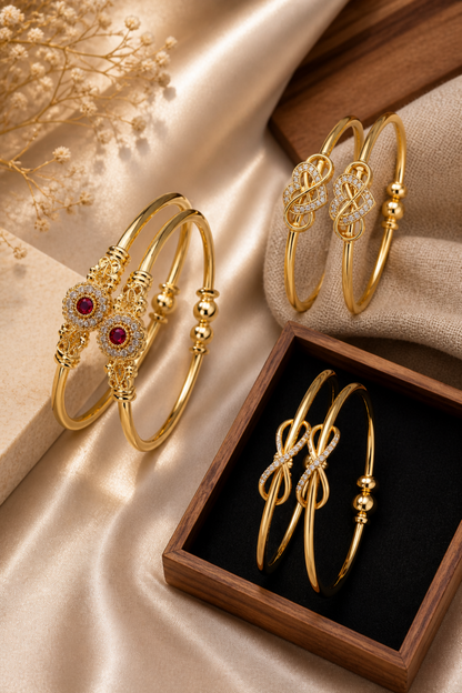 gold bangles with red center stone and clear accents