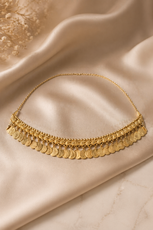 gold waist chain with coin fringe detail on satin fabric