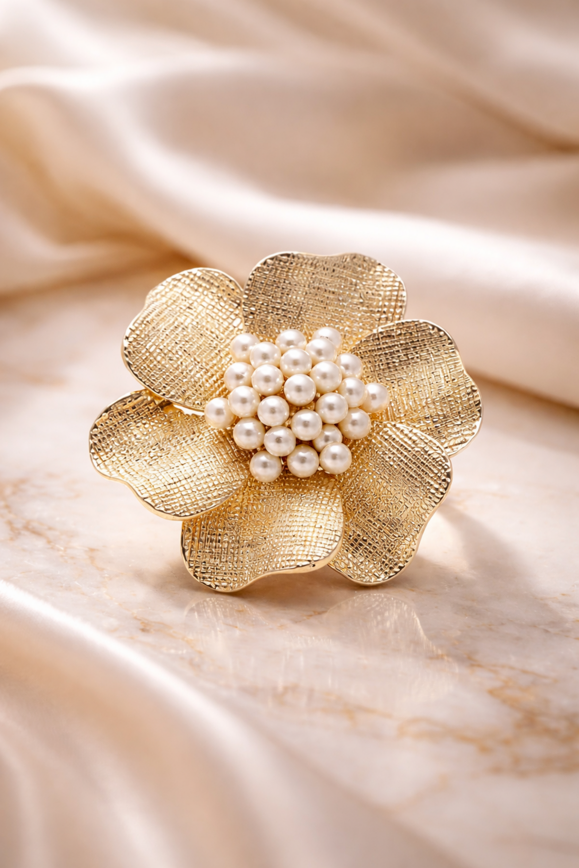 gold flower pearl statement ring close-up
