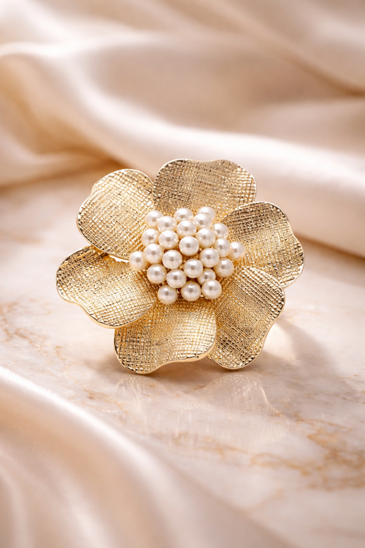 gold flower pearl statement ring close-up
