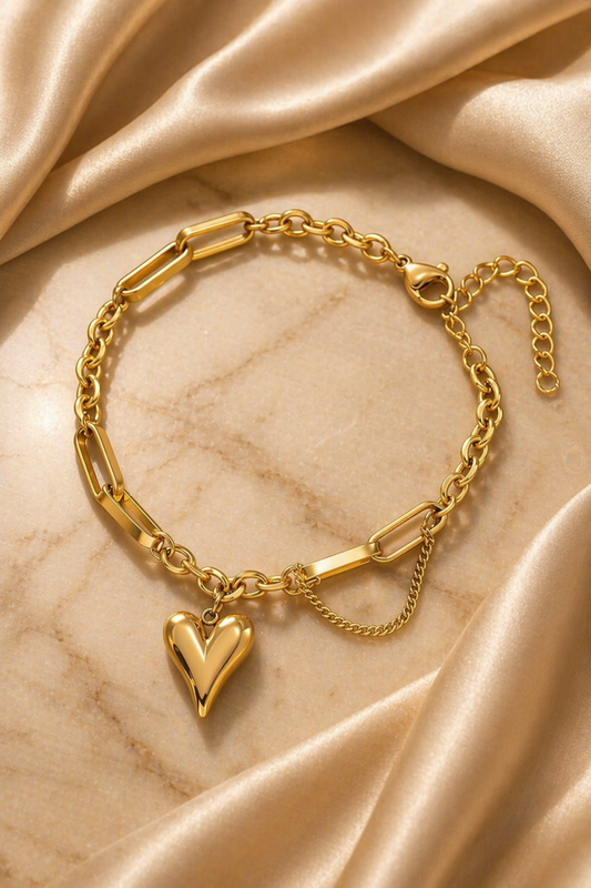 gold heart bracelet on wrist with soft sunlight