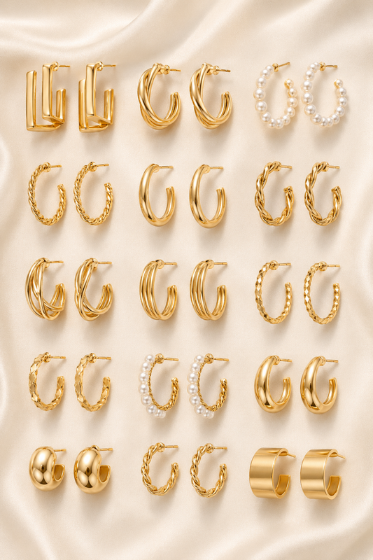 Eighteen gold-tone hoop earring designs arranged in rows on ivory satin