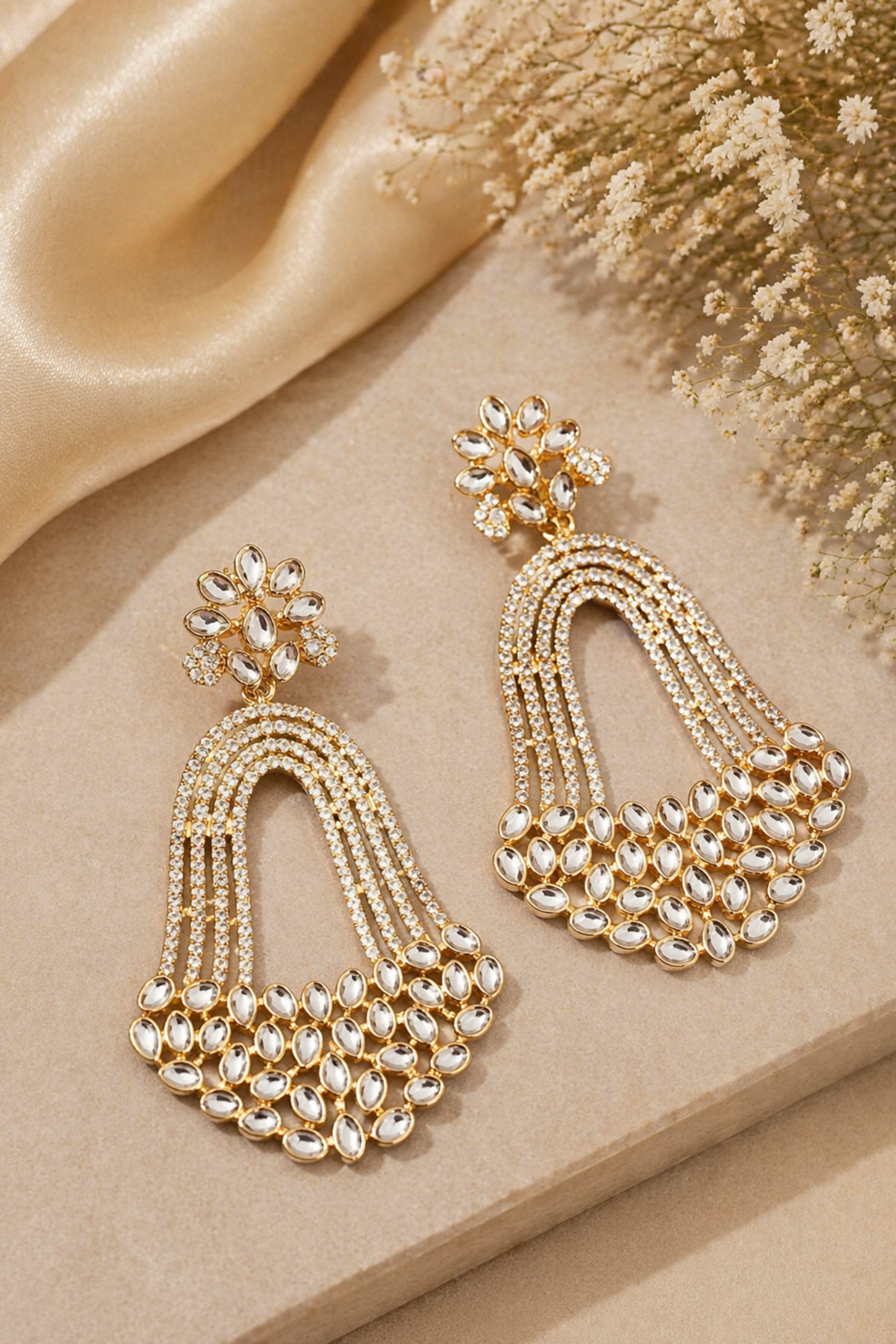 gold kundan chandelier earrings on satin background