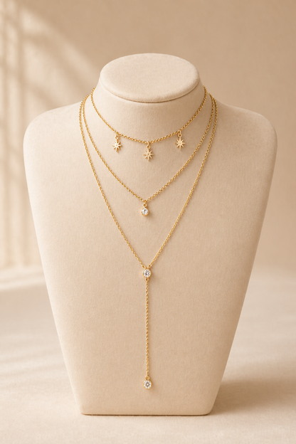 gold layered necklace with star charms and drop pendant