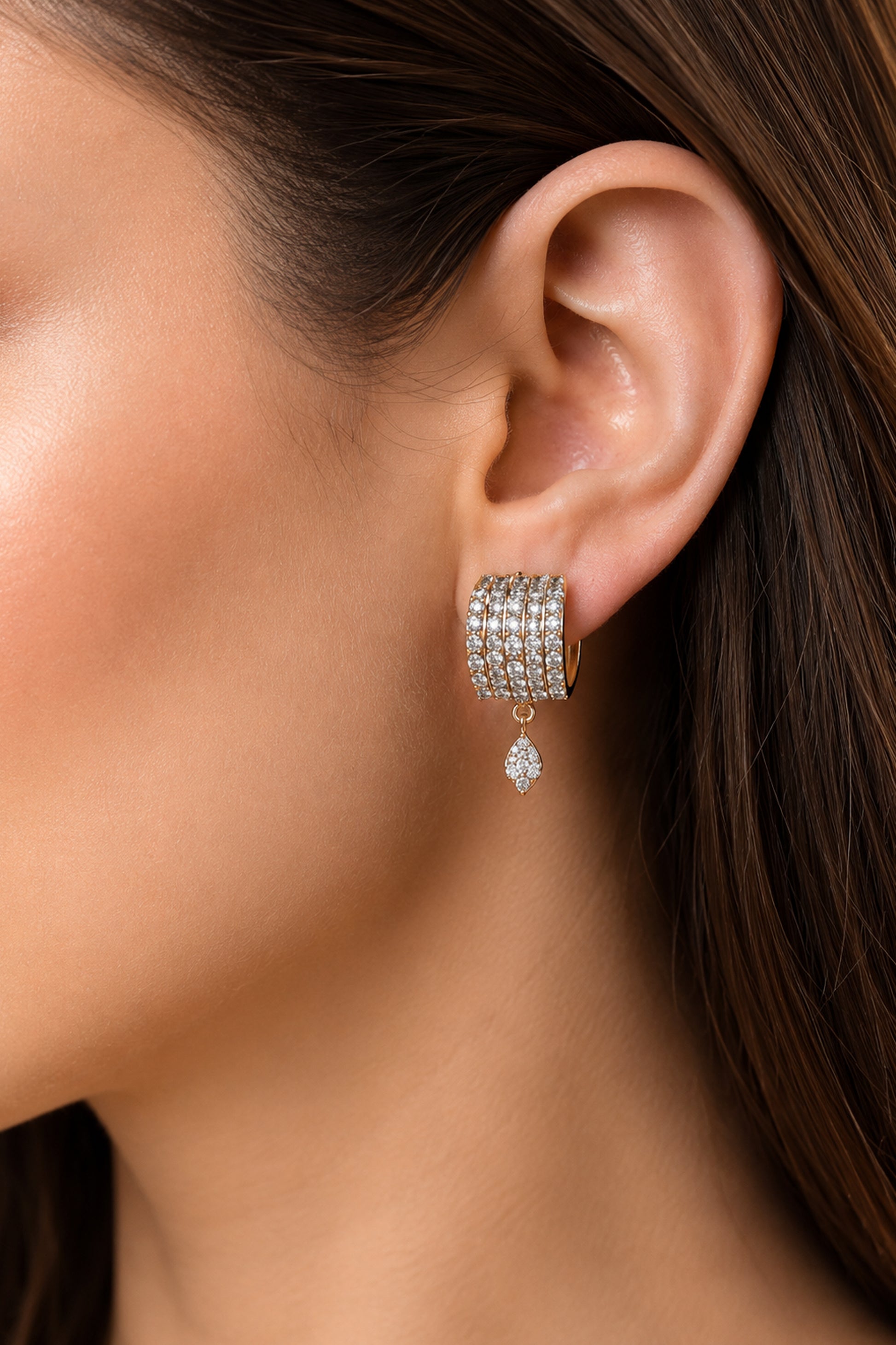 Close-up of wide gold plated hoop earrings
