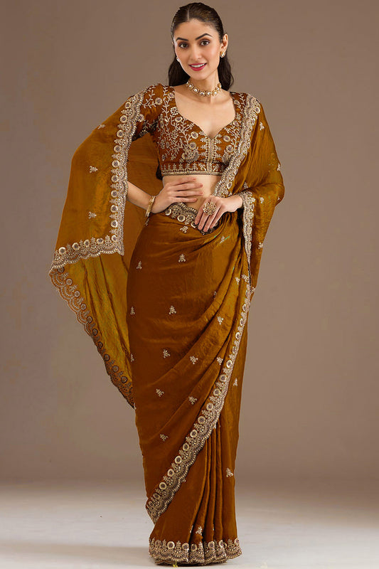 Woman wearing Gold Saree with heavy zari and embroidery